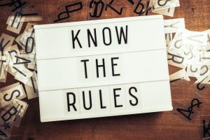 Know The Rules text on the lightbox on wood background