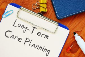 Long-Term Care Planning written on a clipboard.